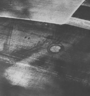 Aerial photograph of a double ring-ditch cropmark at Lydden Valley, now ploughed flat